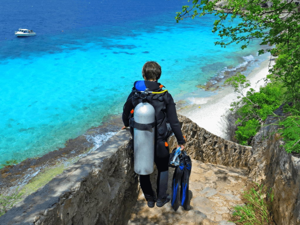 Diver walking down steps to shore dive site